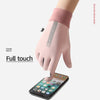 A close-up of a pink velvet glove being used to touch a smartphone screen.