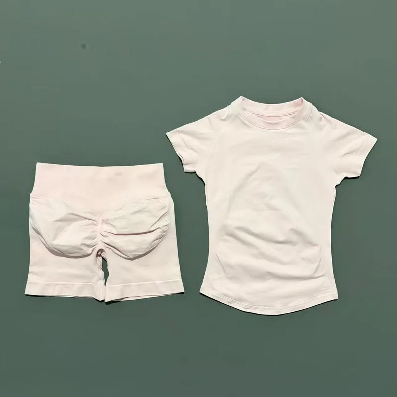 A white seamless yoga set for women featuring a short sleeve top and workout leggings.