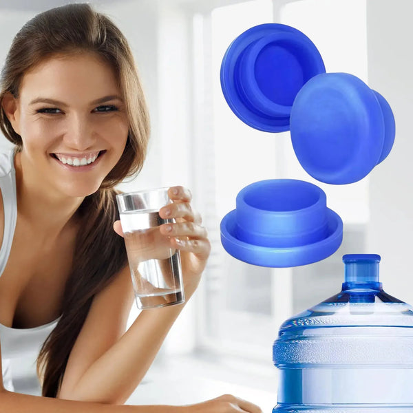 A woman is holding a glass and several blue reusable silicone water bottle lids in a bright indoor setting.
