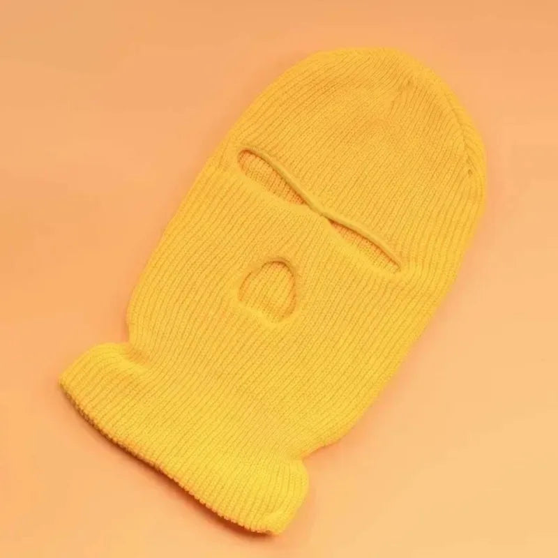 A bright yellow tactical knit balaclava beanie hat shown from the side.