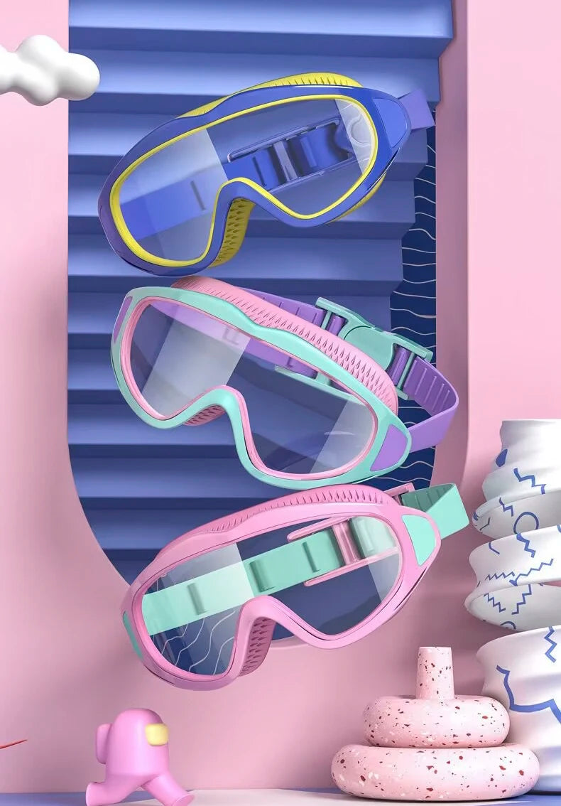 Three pairs of colorful swimming goggles are displayed against a pink background.