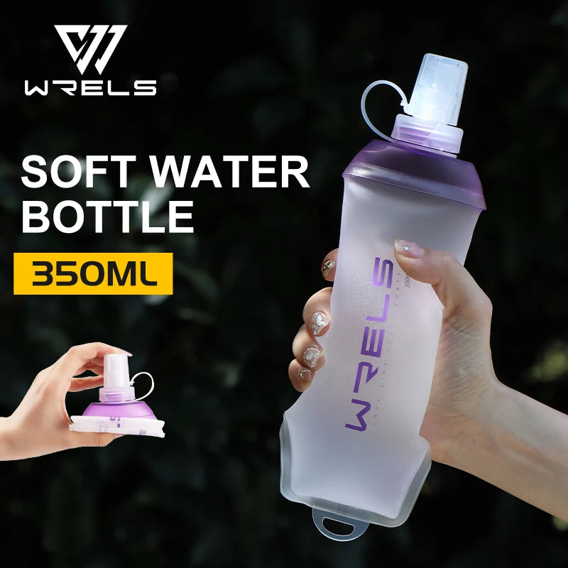 A hand holds a purple soft water bottle with a clear cap against a dark background.