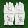 A pair of white microfiber men's golf gloves lying on green grass.