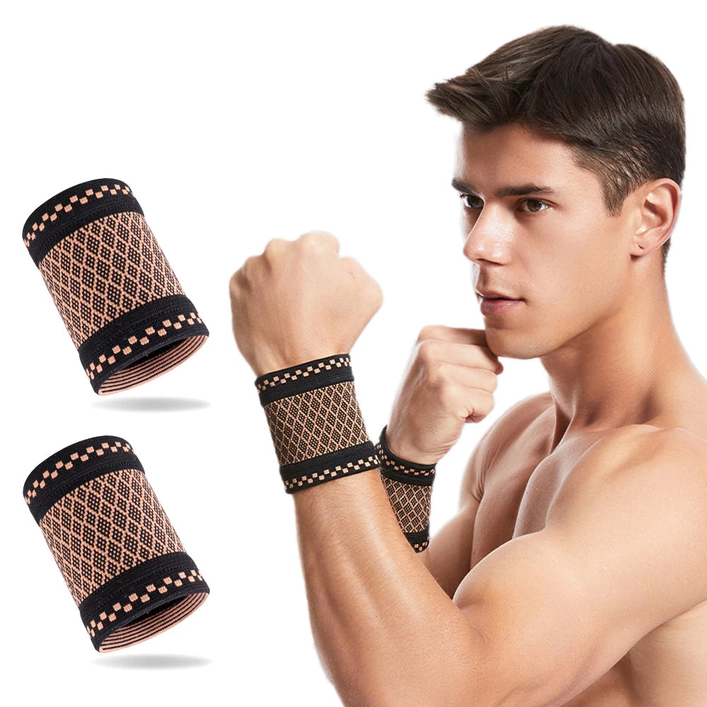 A muscular man wearing copper compression wrist sleeves for pain relief.