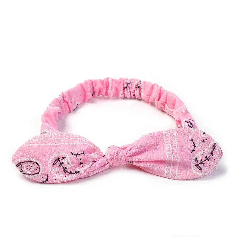 Pink boho paisley elastic hair headbands tied in a bow