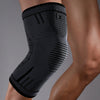 Black compression knee support sleeve worn on a person's leg.
