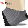 A set of ten pairs of classic women's ankle socks in various shades of gray and black stacked together.