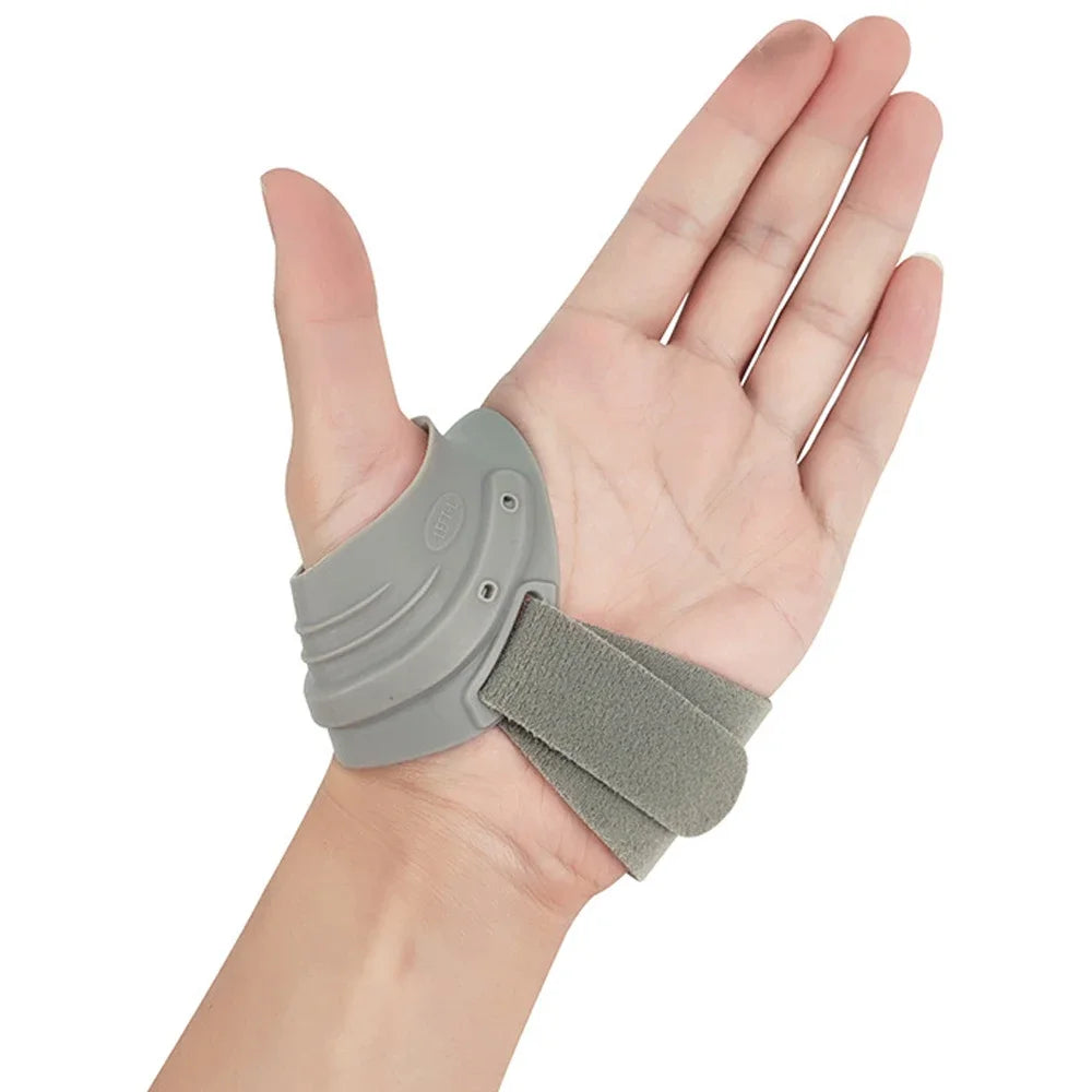 A hand wearing a gray thumb joint stabilizer brace for arthritis pain relief.