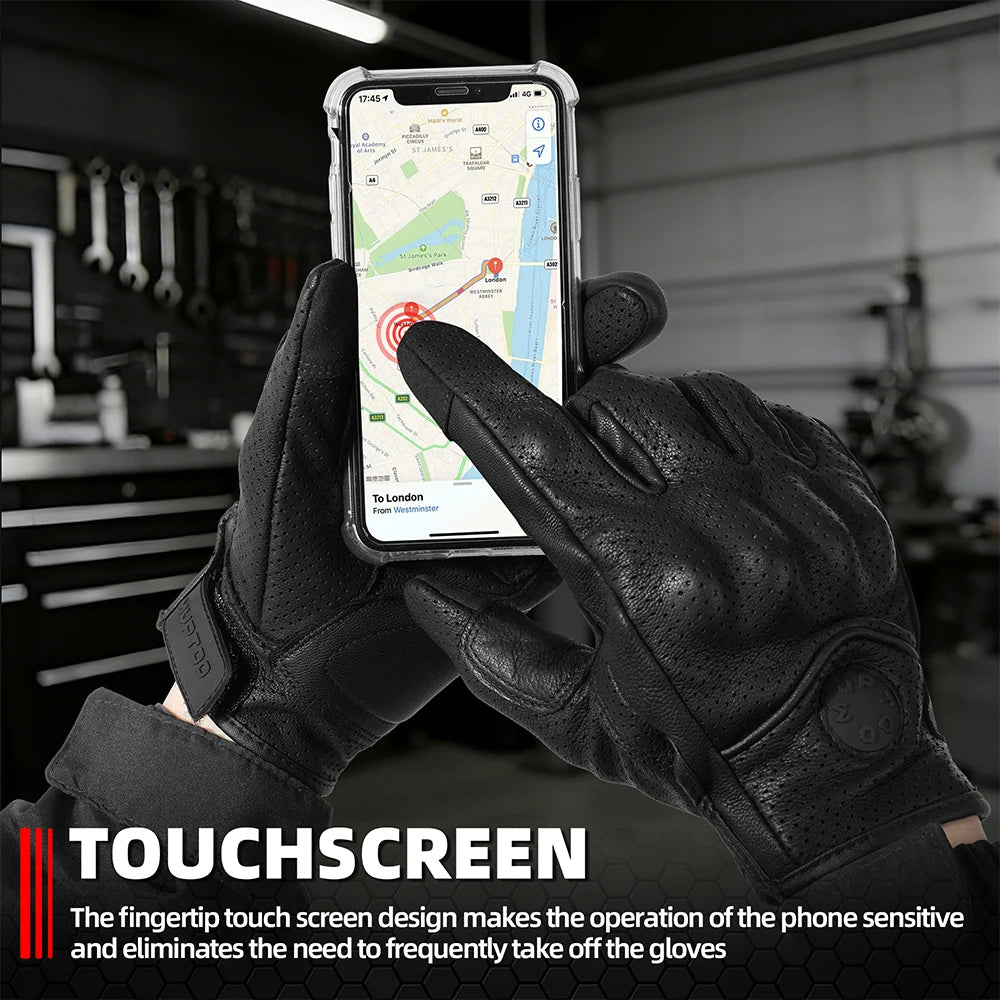 A hand wearing black leather riding gloves is touching a smartphone displaying a map.