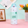A light blue insulated stainless steel sports water bottle with red cherry accents sits on a pink surface.