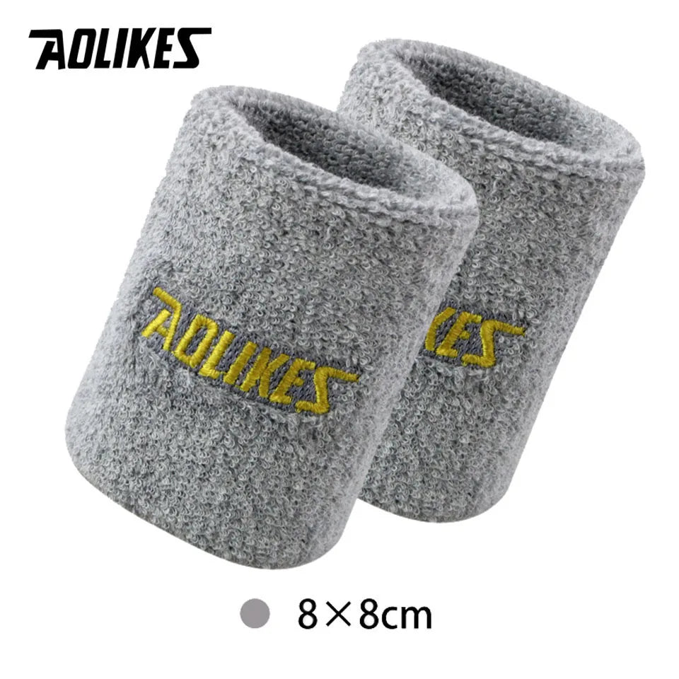 A pair of gray wool wristbands for sport or activewear