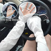 A person wearing white long-sleeved arm sleeves with an anti-drop design is shown gripping a car steering wheel.
