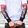 A person wearing a white shirt displays black and pink dotted sports arm cooling sleeves on both arms.