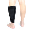 Black adjustable calf compression brace worn on a person's lower leg.