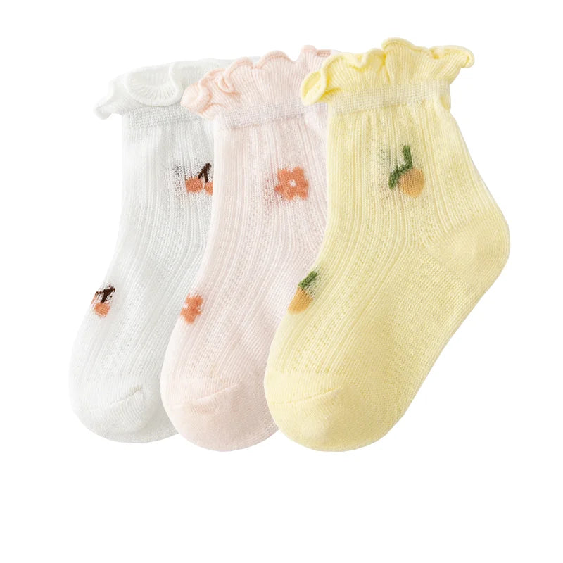 A pack of three thin summer casual baby socks in white, pink, and yellow.