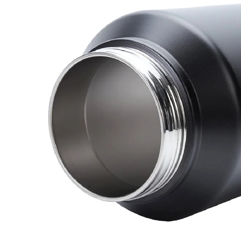 A close-up view of a black insulated stainless steel thermos flask with a silver rim.