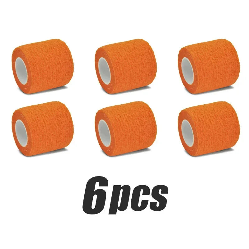 Six orange elastic tattoo grip tapes rolled for finger and wrist protection