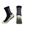 Ein Paar schwarze sportliche Grip-Socken mit weißen Musterakzenten und beige Sohle.