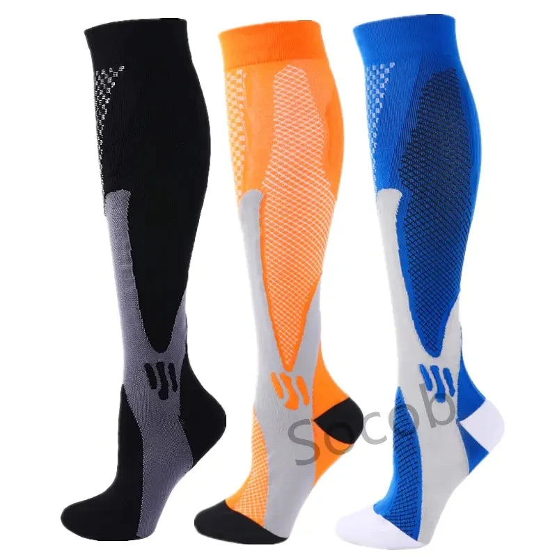 Three pairs of compression socks in black, orange, and blue for athletes and medical use