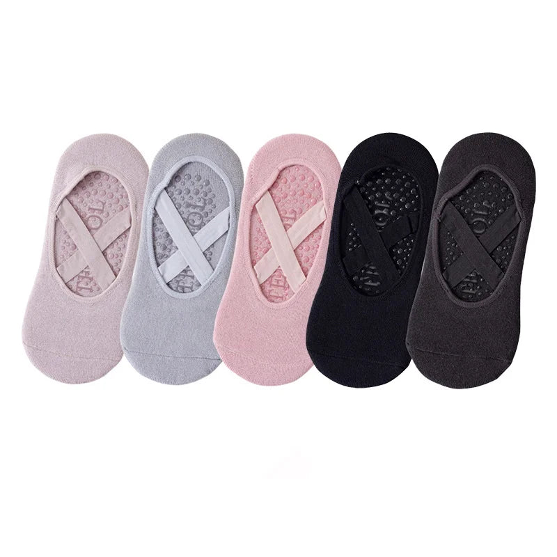 A set of five non-slip yoga and gym socks in various colors including pink, gray, and black.