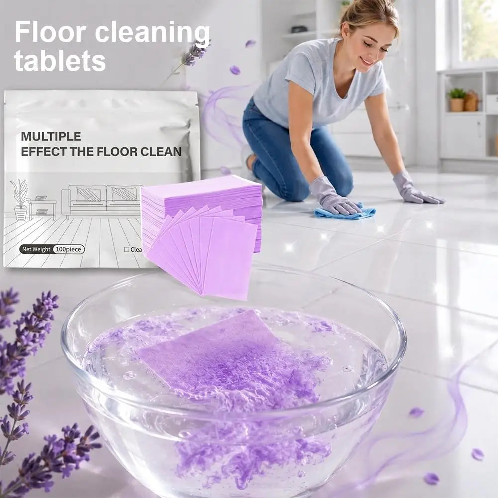 A glass bowl filled with purple floor cleaning tablets and soapy water on a white tiled floor.