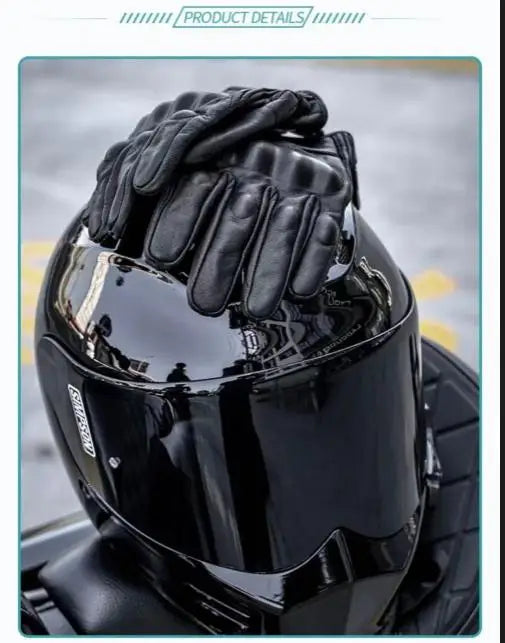 A close-up of black leather motorcycle riding gloves being placed on a helmet.