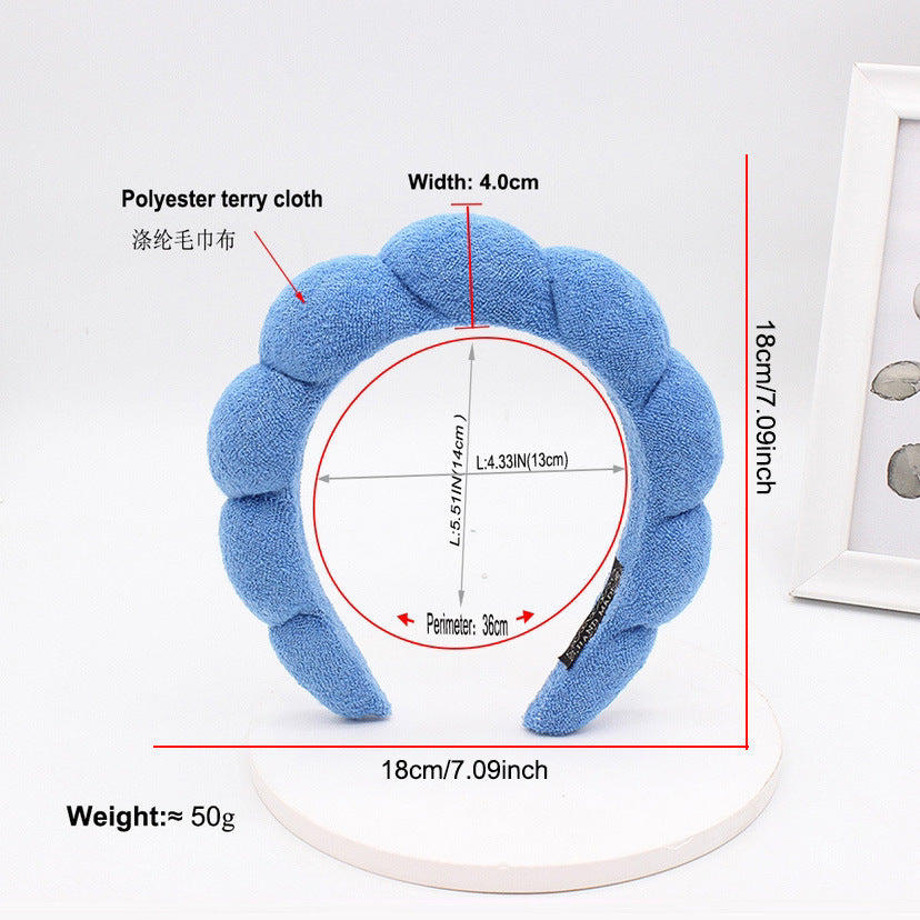 A light blue polyester terry cloth headband for hair styling, shown with dimensions and weight.