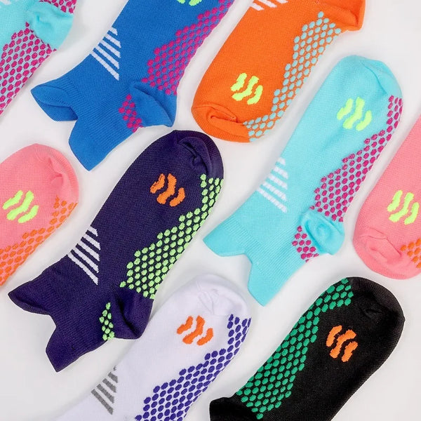 A variety of colorful massage and compression running socks for men laid out on a white background.