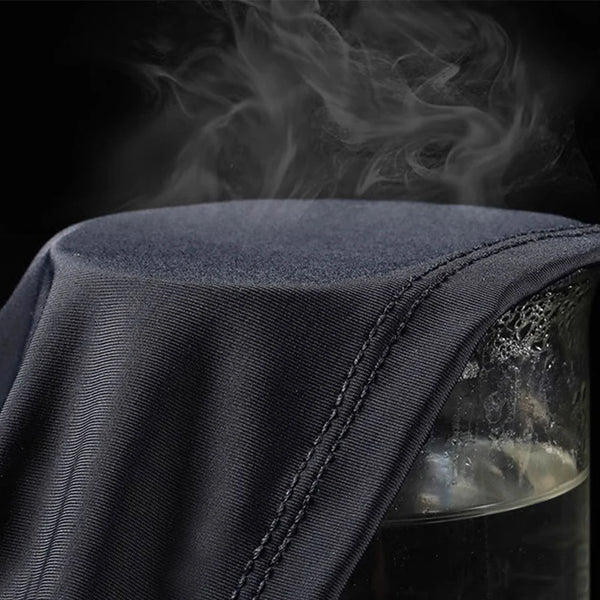 Dark blue breathable arm sleeves being used near a glass container with smoke rising.