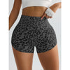 A model is wearing leopard print high-waist seamless shorts and a white cropped top.