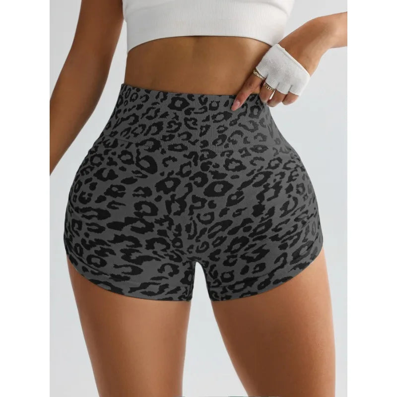 A model is wearing leopard print high-waist seamless shorts and a white cropped top.