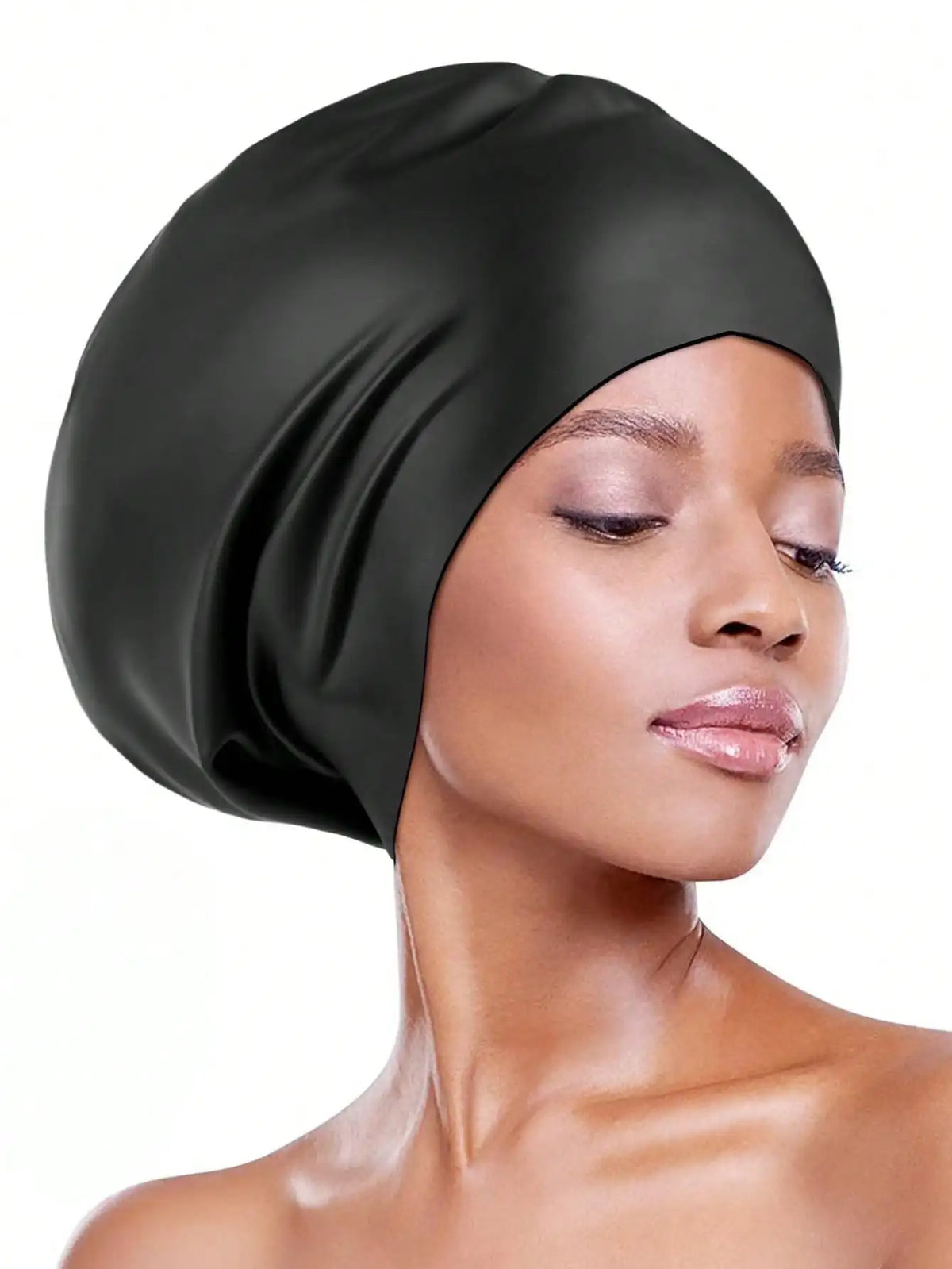 A woman wearing a black silicone swim cap for long hair and braids.