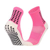 A pair of bright pink and white performance sports grip socks shown from the side.