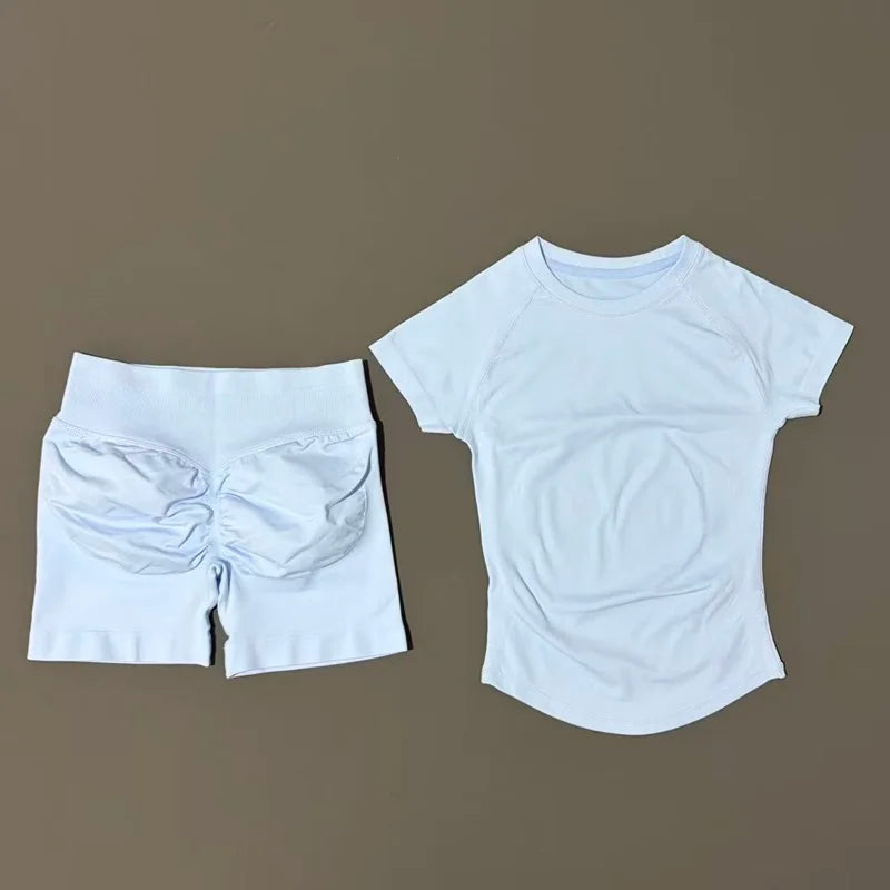 White seamless yoga set for women featuring a short sleeve top and workout leggings.
