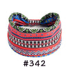 A colorful, patterned boho knotted cotton headband featuring red, black, blue, and white geometric designs.