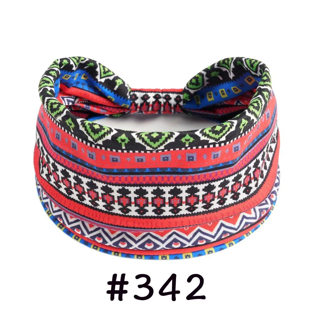 A colorful, patterned boho knotted cotton headband featuring red, black, blue, and white geometric designs.