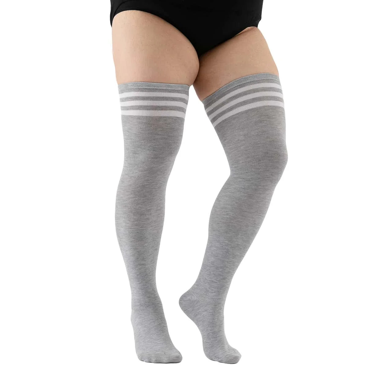 Gray striped thigh high leg warmers worn on a person's leg.