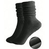 A set of three black silicone pilates and yoga socks stacked vertically.