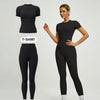 Model in a black sports suit with t-shirt and matching pants.