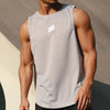 A muscular man wearing a light gray sleeveless sports tank top in an athletic pose.
