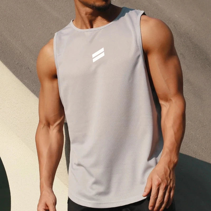 A muscular man wearing a light gray sleeveless sports tank top in an athletic pose.