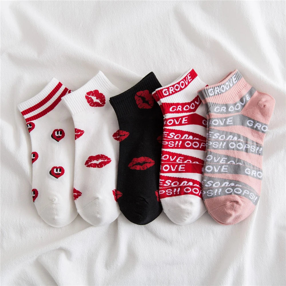 A row of nine novelty striped socks featuring various red and pink lettering designs
