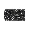 Black fabric headband with white polka dots tied in a bow