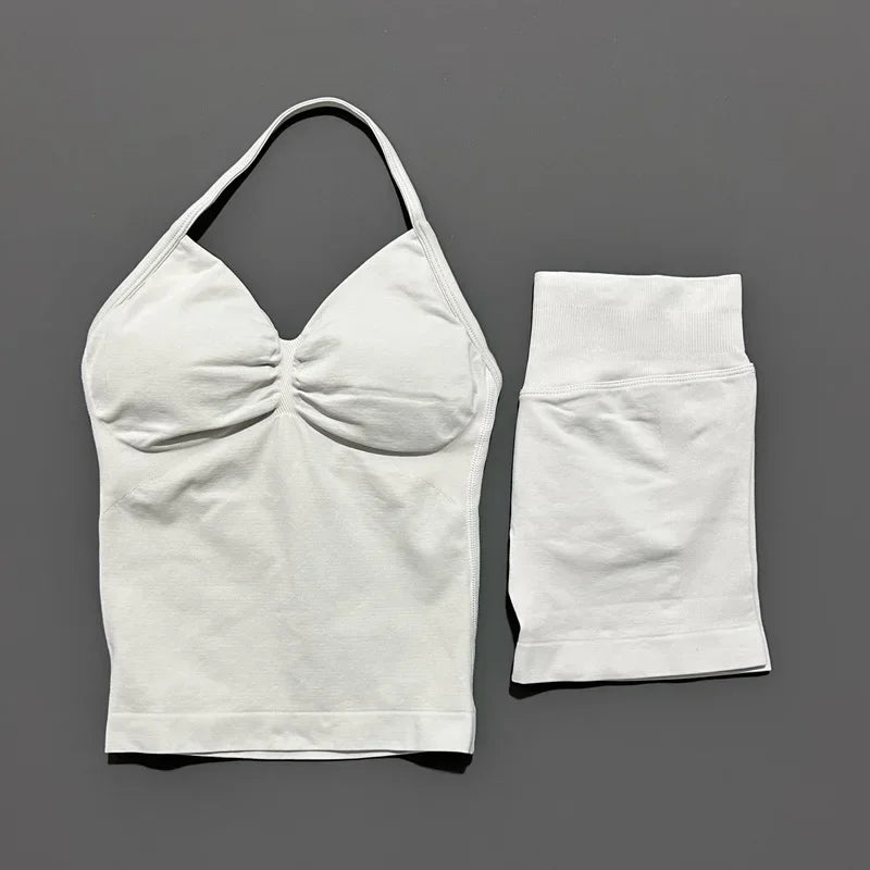 White women's seamless backless fitness set top and bottom shown against a gray background