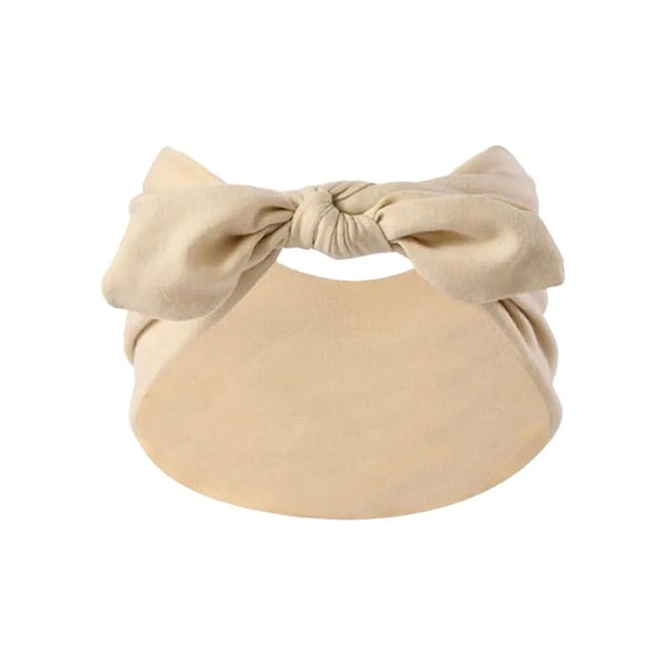 A beige bohemian bunny ear headband with a bow detail.