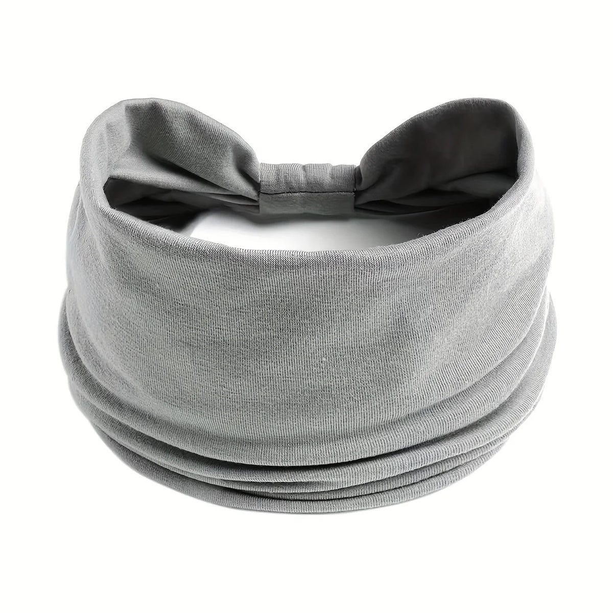 Diadema ancha y elástica gris para el cabello y deportes, doblada y mostrada sobre un fondo blanco.