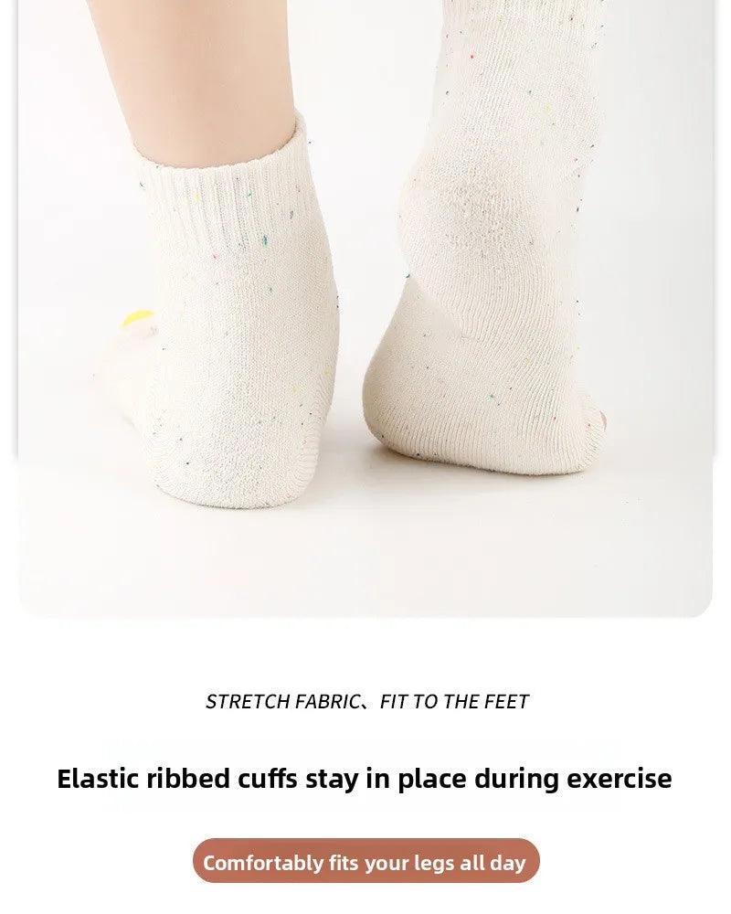 White ribbed elastic cuffs for feet, showing a close-up of the yoga socks.