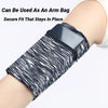 A black and white striped zippered wrist bag is shown secured on a person's arm.