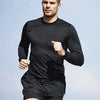 A male model wearing a black performance quick-dry long-sleeve shirt and shorts, posing outdoors.
