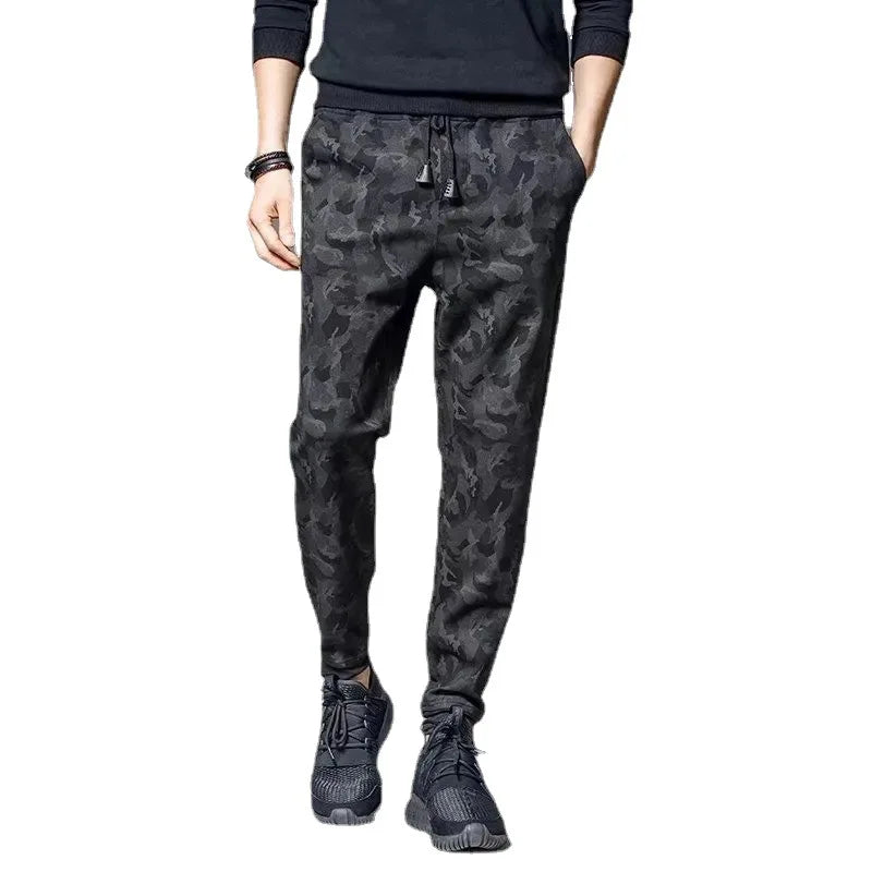 Men's camouflage elastic waist drawstring pants shown on a model.